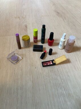 OUAI Pink Bottle with Red Nail Polish and Purple Eyeshadow Makeup Collection